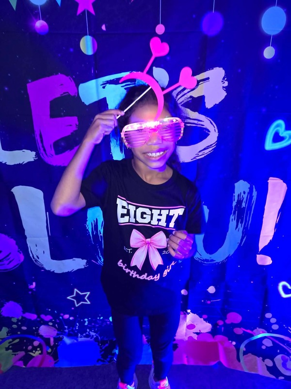 Students in glow party photo booth.
