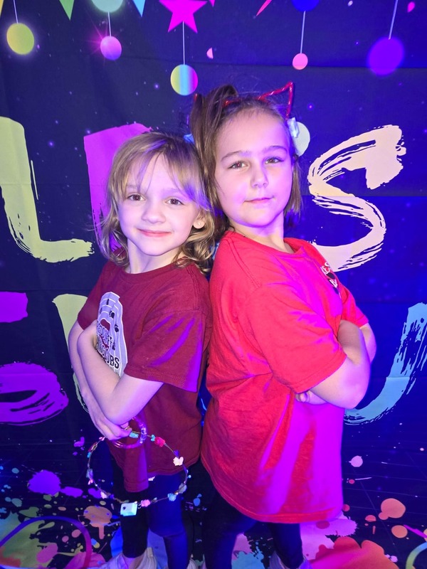 Students in glow party photo booth.