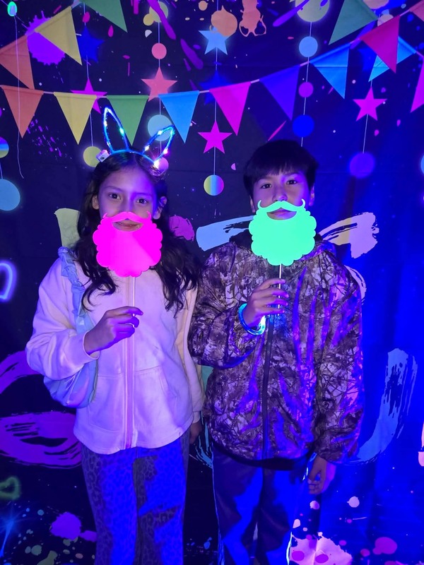 Students in glow party photo booth.