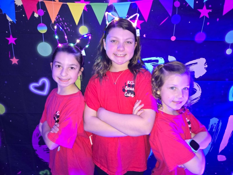 Students in glow party photo booth.