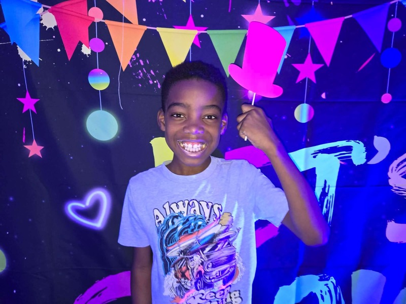 Students in glow party photo booth.