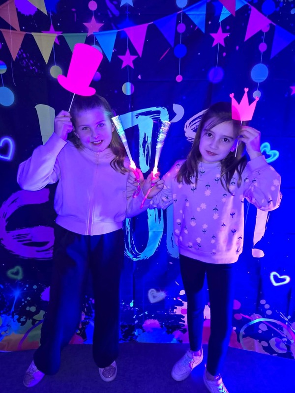Students in glow party photo booth.