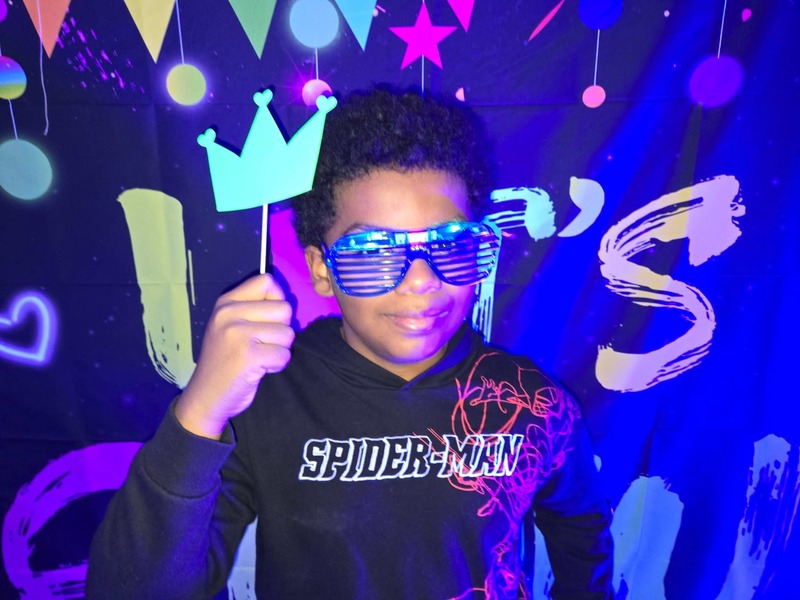 Students in glow party photo booth.