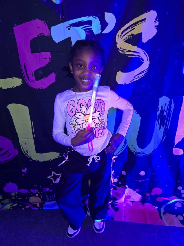 Students in glow party photo booth.