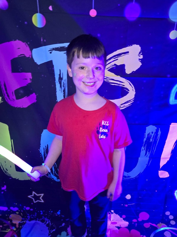 Students in glow party photo booth.