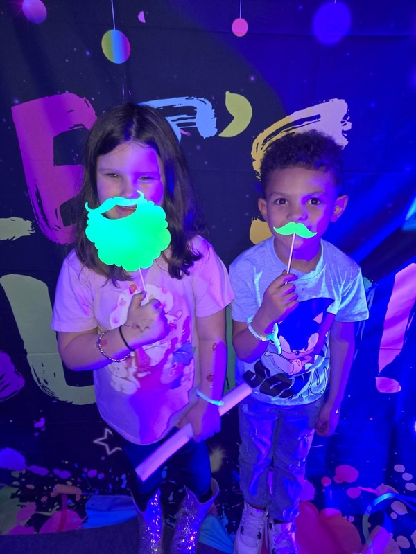 Students in glow party photo booth.
