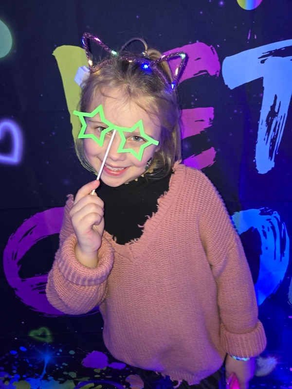 Students in glow party photo booth.
