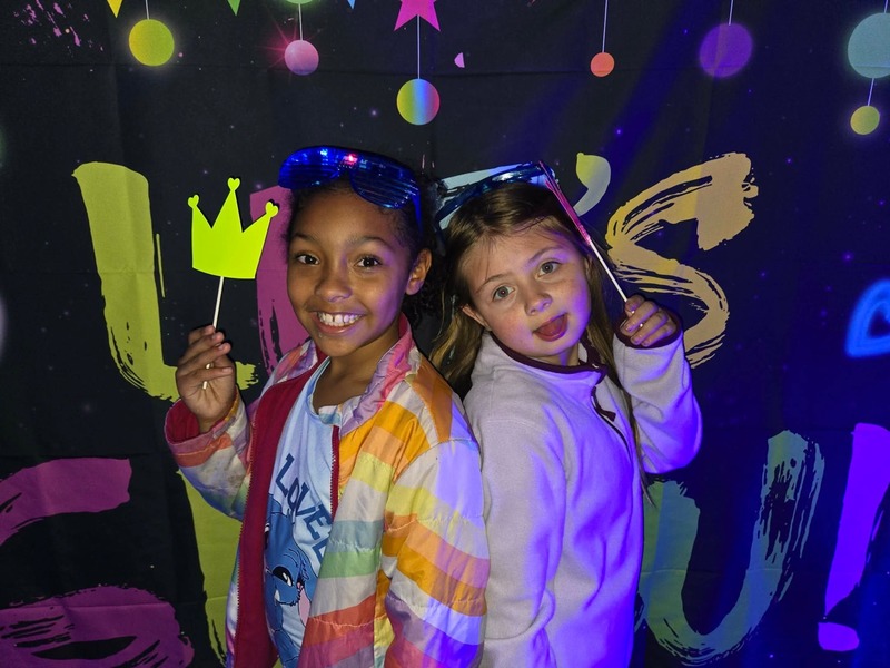 Students in glow party photo booth.