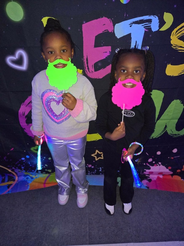 Students in glow party photo booth.