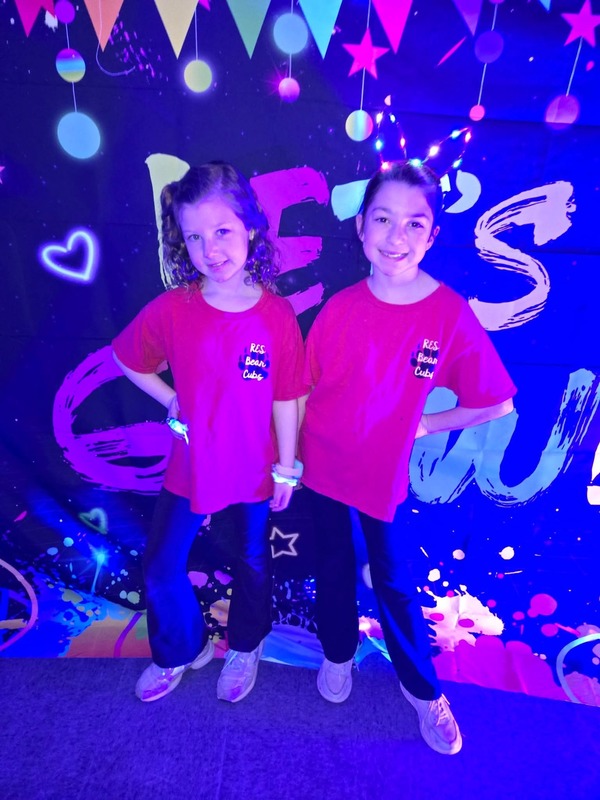 Students in glow party photo booth.