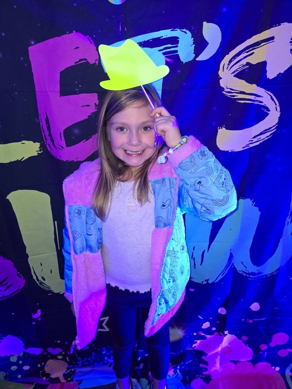 Students in glow party photo booth.