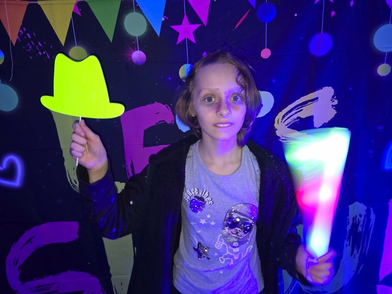 Students in glow party photo booth.