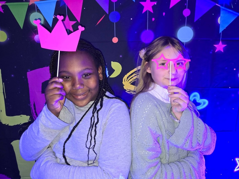 Students in glow party photo booth.