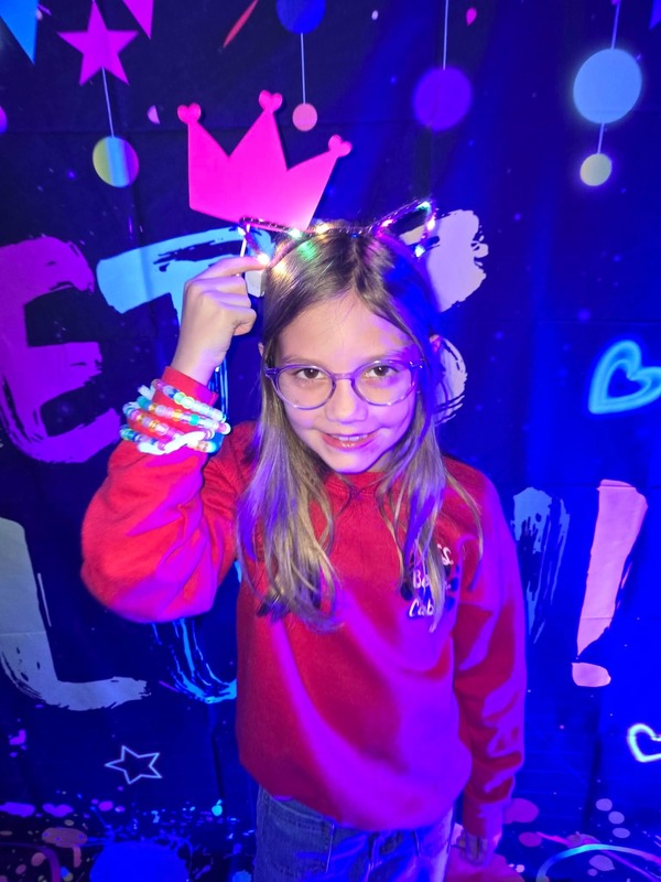 Students in glow party photo booth.