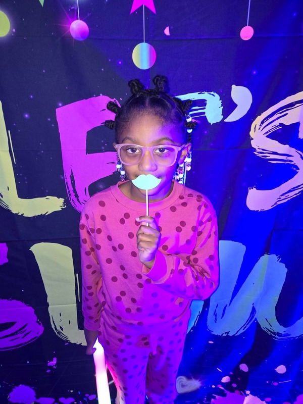 Students in glow party photo booth.