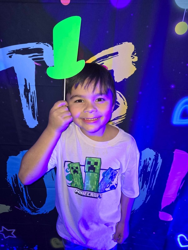 Students in glow party photo booth.