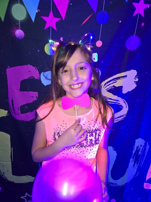 Students in glow party photo booth.