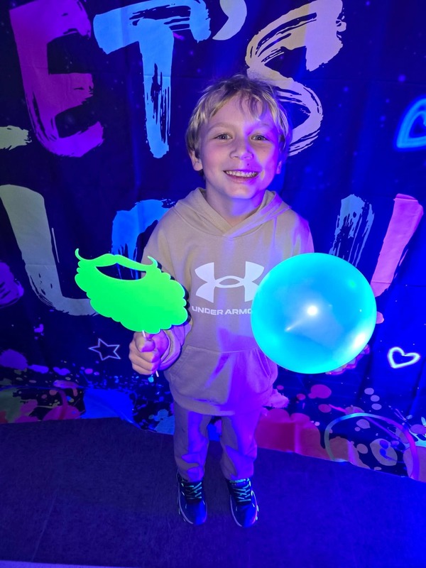 Students in glow party photo booth.