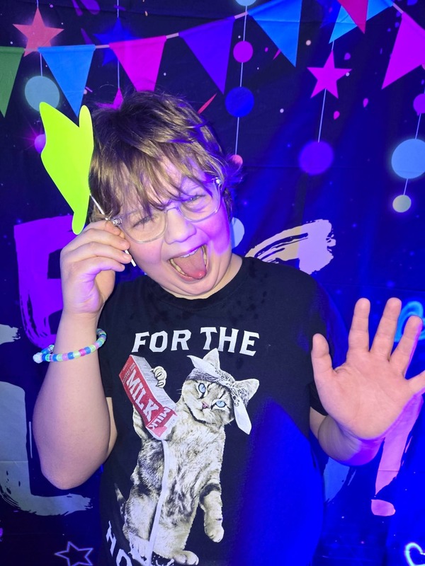 Students in glow party photo booth.