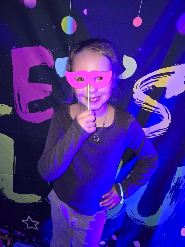 Students in glow party photo booth.