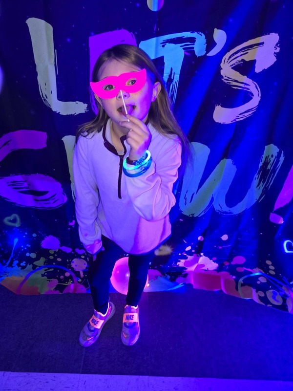 Students in glow party photo booth.