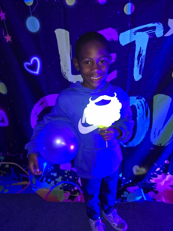 Students in glow party photo booth.