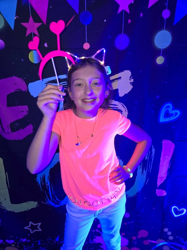 Students in glow party photo booth.