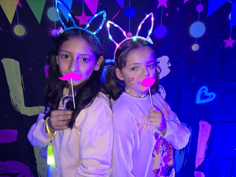 Students in glow party photo booth.