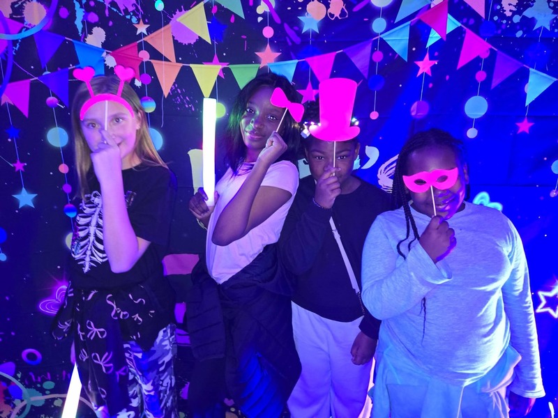 Students in glow party photo booth.