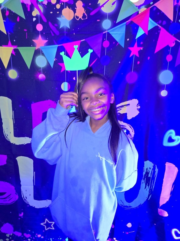 Students in glow party photo booth.