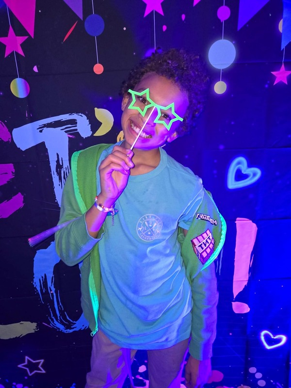 Students in glow party photo booth.