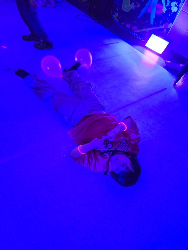 Students in glow party photo booth.