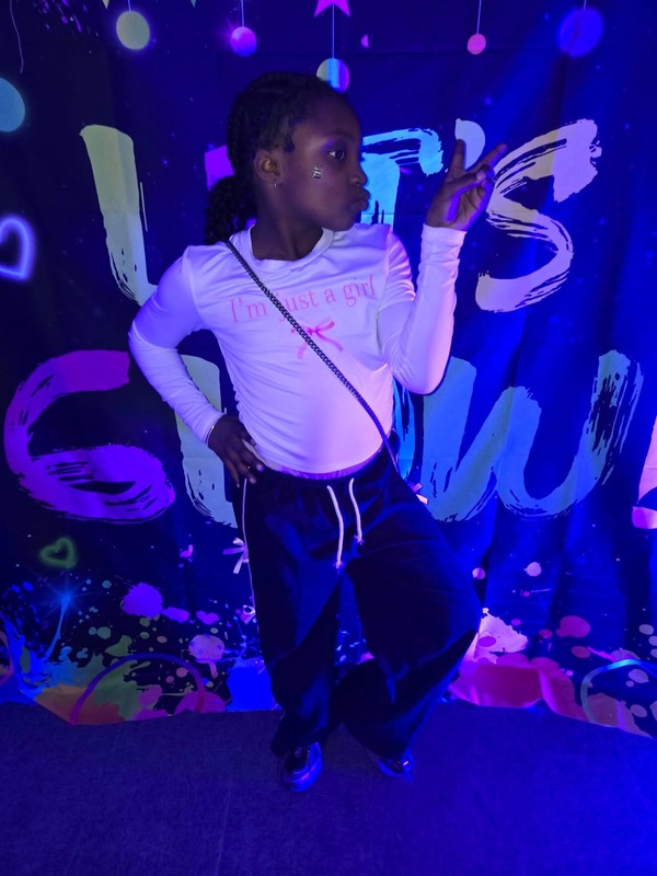 Students in glow party photo booth.