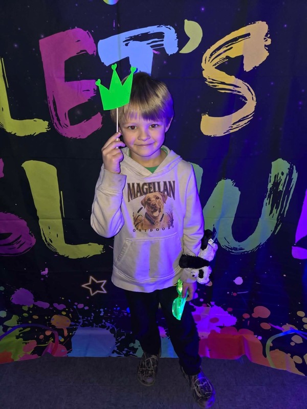 Students in glow party photo booth.