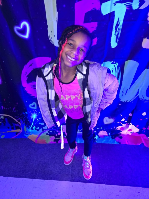 Students in glow party photo booth.