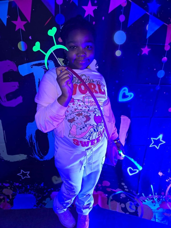 Students in glow party photo booth.