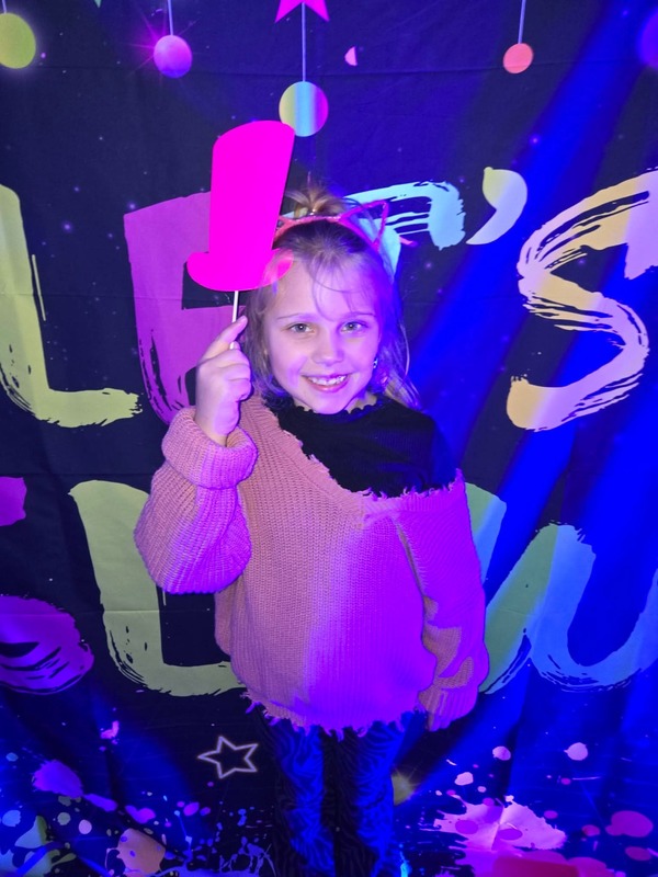 Students in glow party photo booth.