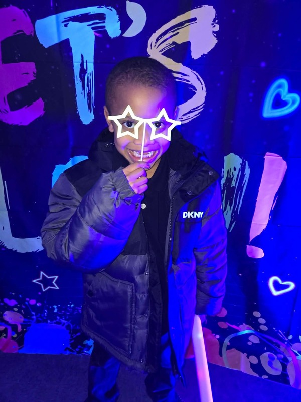 Students in glow party photo booth.