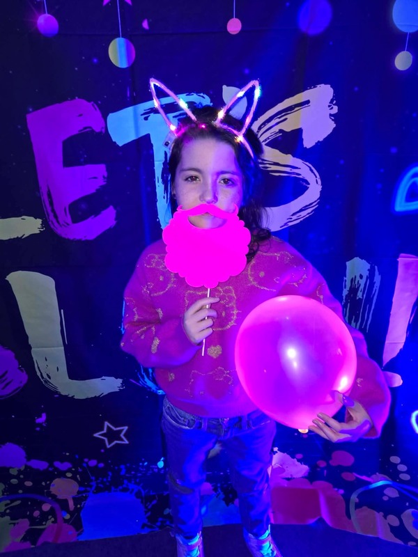 Students in glow party photo booth.