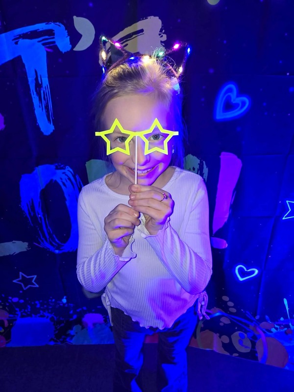 Students in glow party photo booth.