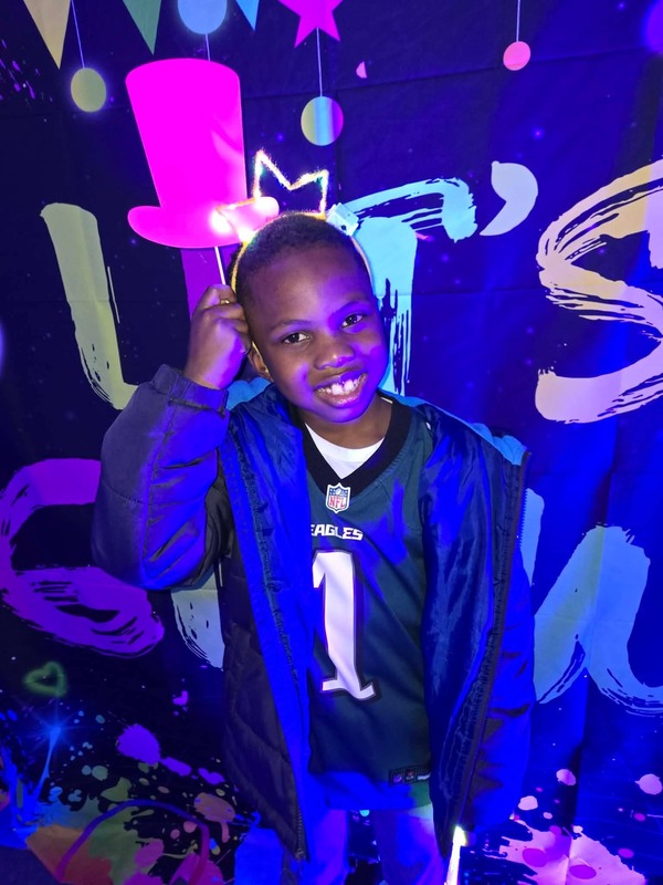 Students in glow party photo booth.