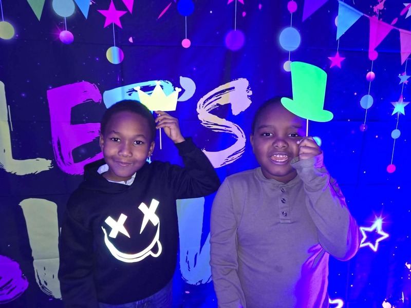 Students in glow party photo booth.