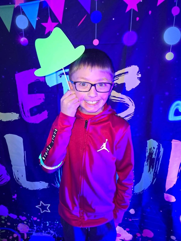 Students in glow party photo booth.