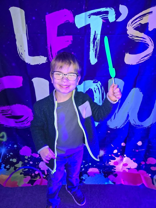 Students in glow party photo booth.