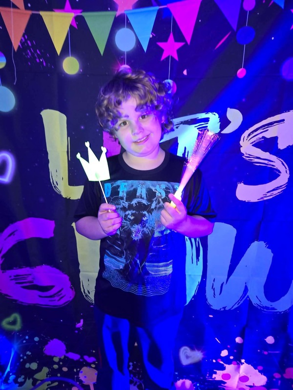 Students in glow party photo booth.