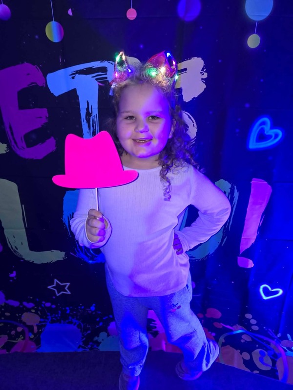 Students in glow party photo booth.