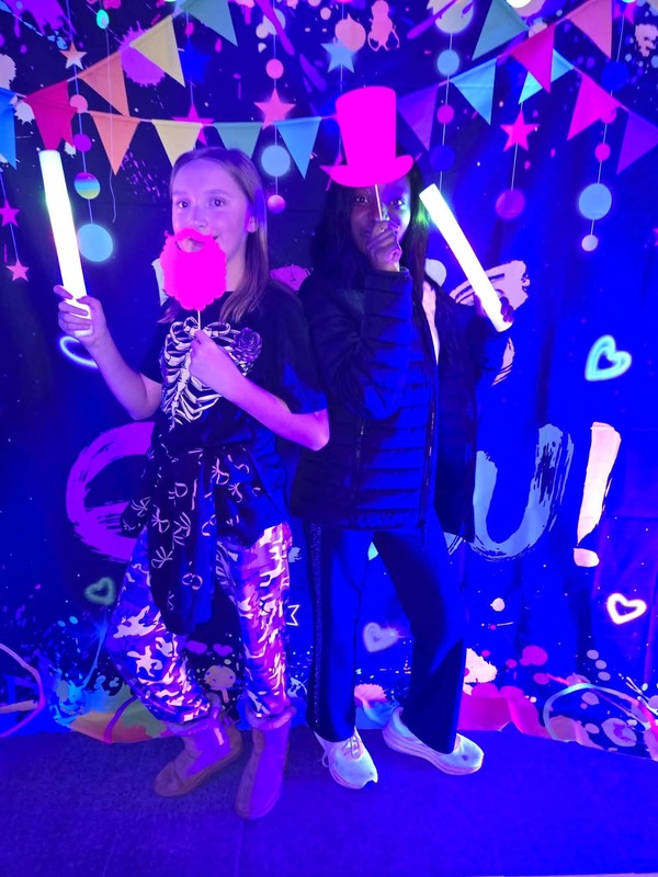 Students in glow party photo booth.