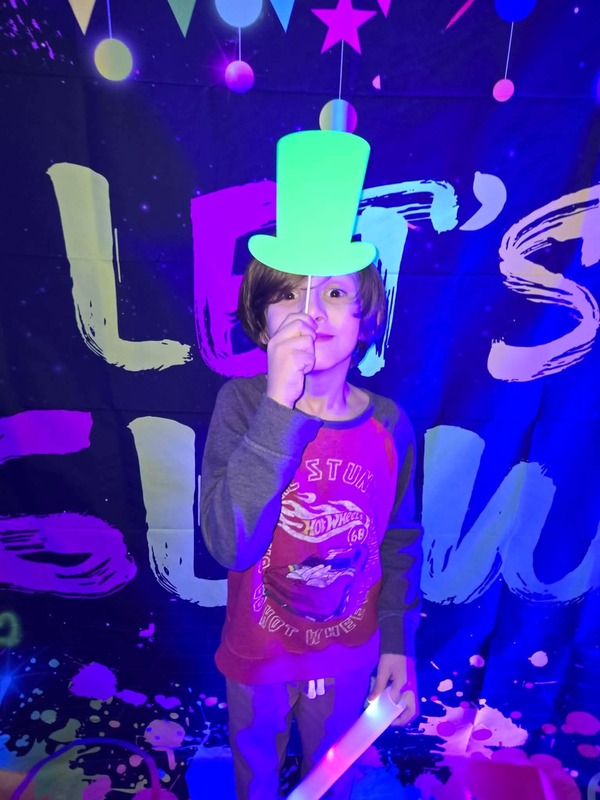 Students in glow party photo booth.