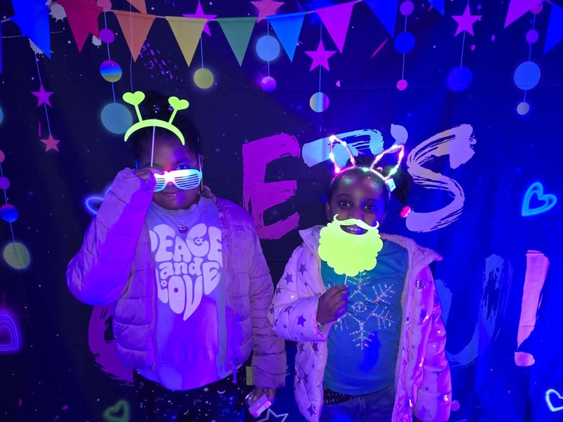 Students in glow party photo booth.