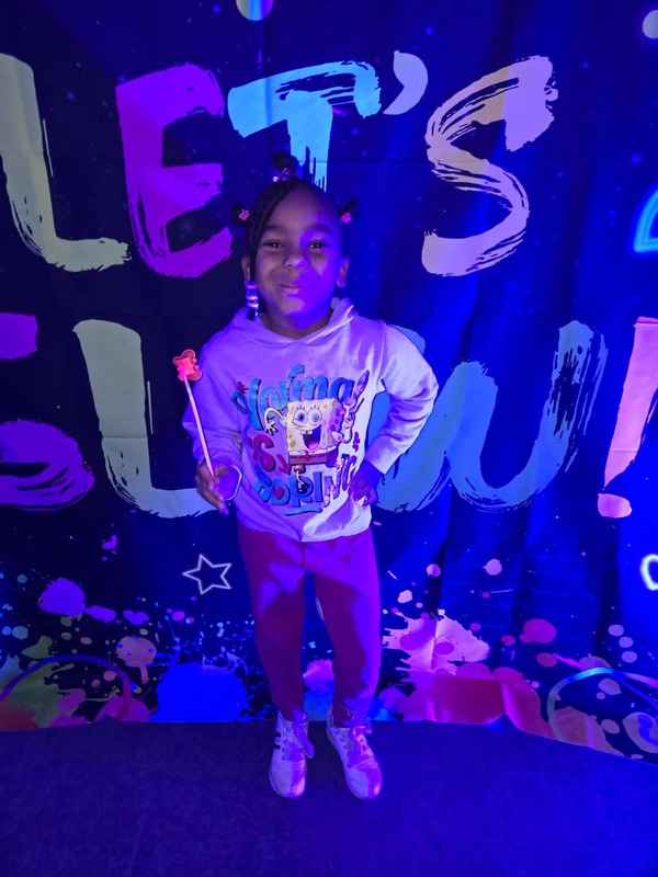 Students in glow party photo booth.